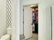Open closet door reveals an organized space filled with colorful clothes on hangers and shelves at 148 Whirlaway Dr, Davenport, FL 33837