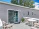 Inviting back porch featuring outdoor seating and a sliding glass door to the home's interior at 15311 Johns Lake Rd, Clermont, FL 34711