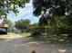 Spacious backyard features a dog kennel, wooden sheds, mature trees and ample space at 15311 Johns Lake Rd, Clermont, FL 34711