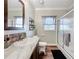 Bathroom featuring a single sink vanity, toilet, and a glass-enclosed shower at 15311 Johns Lake Rd, Clermont, FL 34711