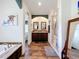 Bathroom featuring a soaking tub, double vanity, and a glass-enclosed shower at 15311 Johns Lake Rd, Clermont, FL 34711