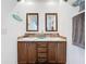 Bathroom featuring a double sink vanity with wood cabinets and mirrors at 15311 Johns Lake Rd, Clermont, FL 34711