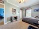 Well-lit bedroom with gray walls, desk, and a window bringing in natural light at 15311 Johns Lake Rd, Clermont, FL 34711