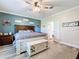 Spacious bedroom with a large bed, chest, and soothing color scheme at 15311 Johns Lake Rd, Clermont, FL 34711