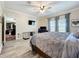 Comfortable bedroom features a large bed, TV, and natural light at 15311 Johns Lake Rd, Clermont, FL 34711