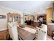 Open concept dining room leading to living room and kitchen, wood floors, and neutral walls at 15311 Johns Lake Rd, Clermont, FL 34711