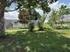 Manufactured home with a large wooden deck and landscaped yard at 15311 Johns Lake Rd, Clermont, FL 34711