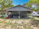 Large covered outdoor structure with tables, seating, and multiple grills for outdoor entertaining at 15311 Johns Lake Rd, Clermont, FL 34711