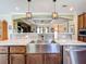 Lovely kitchen with stainless steel farm sink, marble countertops, and pendant lighting at 15311 Johns Lake Rd, Clermont, FL 34711