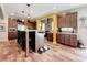 Spacious kitchen featuring a center island, wood floors, modern appliances, and stylish lighting at 15311 Johns Lake Rd, Clermont, FL 34711