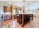 Open kitchen featuring hardwood floors, modern pendant lights, and a long island at 15311 Johns Lake Rd, Clermont, FL 34711