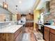 Charming kitchen featuring wood floors, stylish cabinets, stainless appliances, and brick accents at 15311 Johns Lake Rd, Clermont, FL 34711