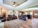Spacious living room featuring hardwood floors, a ceiling fan, and leather reclining furniture at 15311 Johns Lake Rd, Clermont, FL 34711