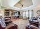 Comfortable living room featuring a tv, custom shelving, and lots of natural light at 15311 Johns Lake Rd, Clermont, FL 34711