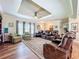 Beautiful living room with recessed ceiling, fireplace, and lots of comfortable seating at 15311 Johns Lake Rd, Clermont, FL 34711