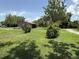 Spacious yard with mature trees, a storage shed, and a utility shed at 15311 Johns Lake Rd, Clermont, FL 34711