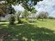 Lush green lawn with mature trees and landscaping at 15311 Johns Lake Rd, Clermont, FL 34711