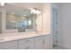 Bathroom with a large mirror, double vanity, and a view of the walk-in shower at 15600 Vetta Dr, Bella Collina, FL 34756