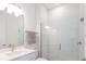 Modern bathroom featuring a glass-enclosed shower, white tile, and sleek fixtures at 15600 Vetta Dr, Bella Collina, FL 34756