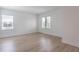 Spacious bedroom with ample natural light, wood laminate flooring, and clean design elements at 15600 Vetta Dr, Bella Collina, FL 34756