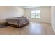 Bright bedroom with a bed, side table and view of the yard, showcasing comfort and style at 15600 Vetta Dr, Bella Collina, FL 34756