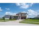 Beautiful two-story home featuring a tile roof, stone accents, a two-car garage, and a well-manicured front lawn at 15600 Vetta Dr, Bella Collina, FL 34756