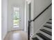 Bright foyer with hardwood floors, a staircase, and a view of the front yard at 15600 Vetta Dr, Bella Collina, FL 34756