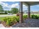 Inviting front porch with stone pillars, manicured landscaping, and a brick pathway at 15600 Vetta Dr, Bella Collina, FL 34756