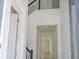 Well-lit hallway with hardwood floors and access to other rooms in the home at 15600 Vetta Dr, Bella Collina, FL 34756