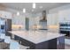 Bright kitchen with a large island, stainless steel appliances, and modern lighting at 15600 Vetta Dr, Bella Collina, FL 34756