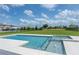 Relaxing backyard pool with a built-in spa, a spacious patio, and a lush green lawn at 15600 Vetta Dr, Bella Collina, FL 34756