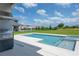 Swimming pool with a spa, built-in grill, and backyard space, great for outdoor entertaining and relaxation at 15600 Vetta Dr, Bella Collina, FL 34756