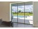 Backyard view with a swimming pool, patio area, and lush greenery, creating a perfect outdoor oasis at 15600 Vetta Dr, Bella Collina, FL 34756