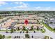 Expansive aerial view of townhomes with tile roofs, lush landscaping, and ample parking in a desirable community at 1565 Plunker Dr, Davenport, FL 33896