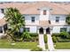 Detailed aerial shot of a townhome showcasing landscaping and tile roofing at 1565 Plunker Dr, Davenport, FL 33896