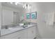 Bright bathroom with double sinks and vanity and a large mirror at 1565 Plunker Dr, Davenport, FL 33896