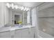 Bright bathroom with double sinks, lots of lights and a shower/tub combo at 1565 Plunker Dr, Davenport, FL 33896