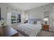 Stylish bedroom with a decorative accent wall, bedside tables and lamps, complemented by a bright window view at 1565 Plunker Dr, Davenport, FL 33896