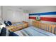 bedroom with twin beds, bright blue accents, cartoon mural and a TV at 1565 Plunker Dr, Davenport, FL 33896