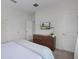 Minimalist bedroom featuring a flat-screen TV, dresser, and access to other rooms through two doors at 1565 Plunker Dr, Davenport, FL 33896