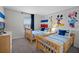 bedroom with twin beds, bright blue accents, and a cartoon mural at 1565 Plunker Dr, Davenport, FL 33896