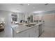 Open kitchen layout with a large island, stainless steel appliances, and modern finishes at 1565 Plunker Dr, Davenport, FL 33896