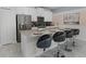 Modern kitchen featuring an island with bar seating, stainless steel appliances, and white cabinets at 1565 Plunker Dr, Davenport, FL 33896