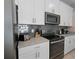 Close up of a modern kitchen featuring gray backsplash and stainless steel appliances at 1565 Plunker Dr, Davenport, FL 33896