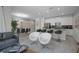 Bright, open-concept living room and kitchen area, with modern furnishings and decor at 1565 Plunker Dr, Davenport, FL 33896