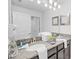 Bathroom with double sinks and granite countertops at 1578 Slice Way, Davenport, FL 33896
