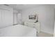 Bright bedroom with a queen bed, a flat screen TV, and a large dresser at 1578 Slice Way, Davenport, FL 33896