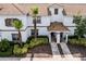 Charming two-story townhome features well-maintained landscaping, a private entrance and brown accents on the shutters and roof at 1578 Slice Way, Davenport, FL 33896