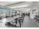 Bright community gym featuring various machines, free weights and a wall of windows at 1578 Slice Way, Davenport, FL 33896