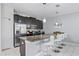 Kitchen featuring granite countertops, stainless steel appliances, and sleek dark wood cabinetry at 1578 Slice Way, Davenport, FL 33896